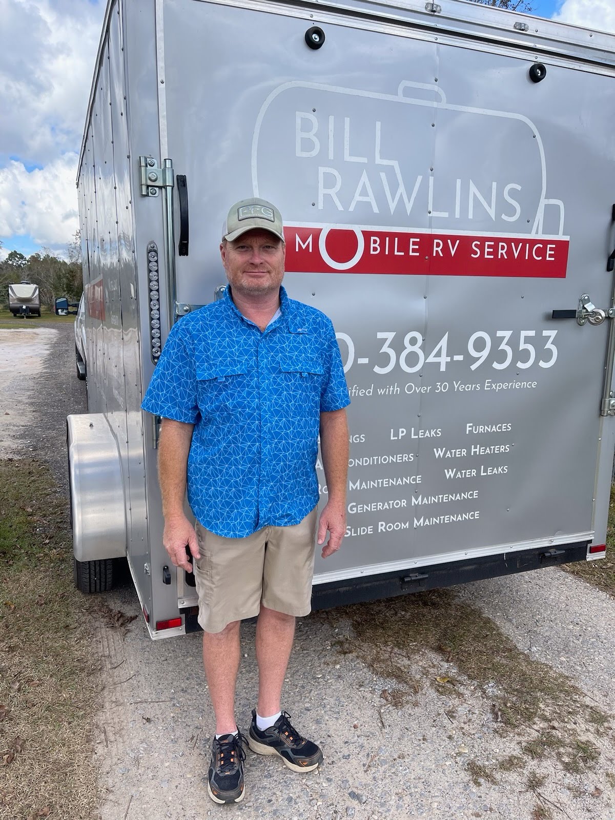 Photo of Bill Rawlins standing in front of a trailer